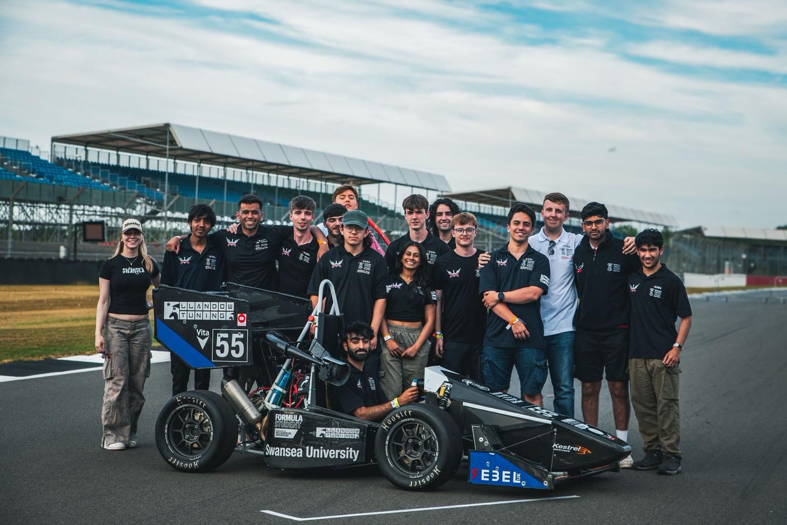 Swansea University Race Engineering students gathered with their Formula Student car at Silverstone